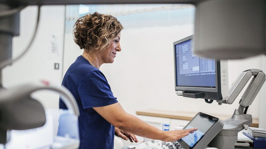 Healthcare worker using ultrasound machine