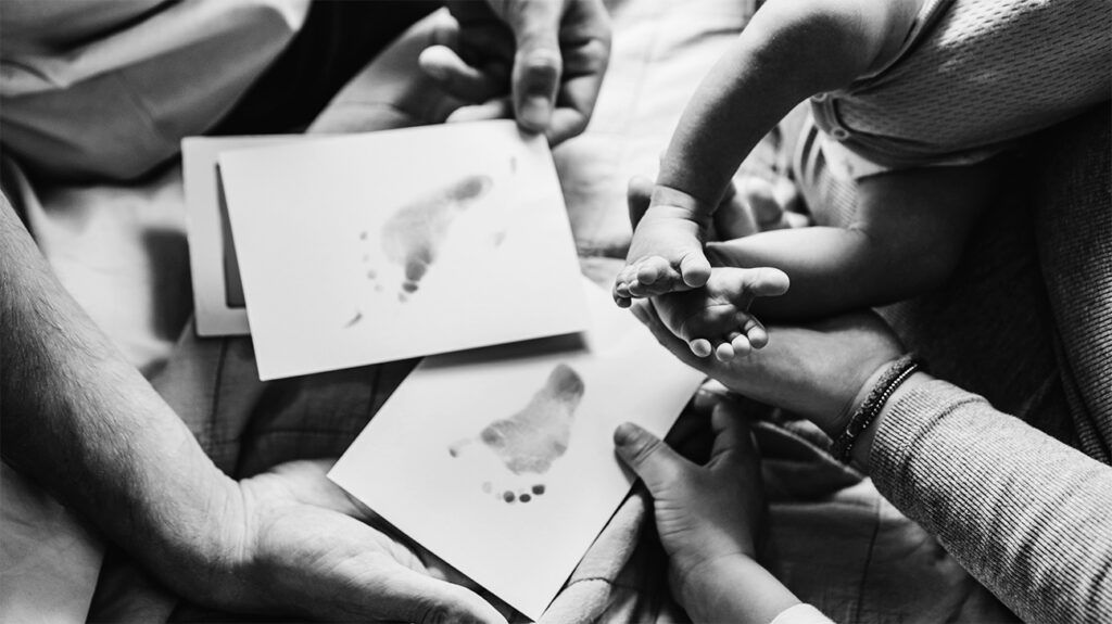 A couple making foot prints from their baby. -3