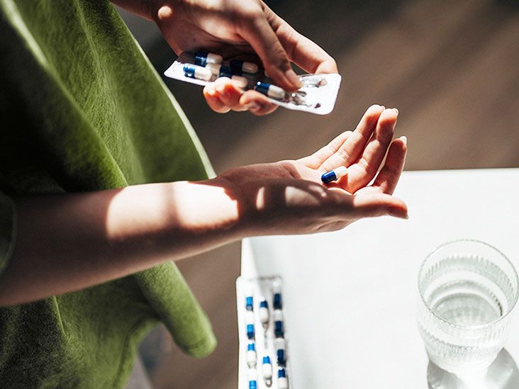 woman dispensing pills from blister pack