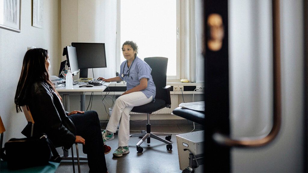 A healthcare professional discussing a small cell lung cancer misdiagnosis with a patient.