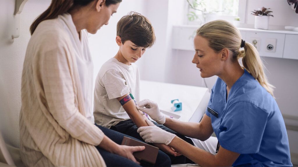 Young male child getting blood drawn