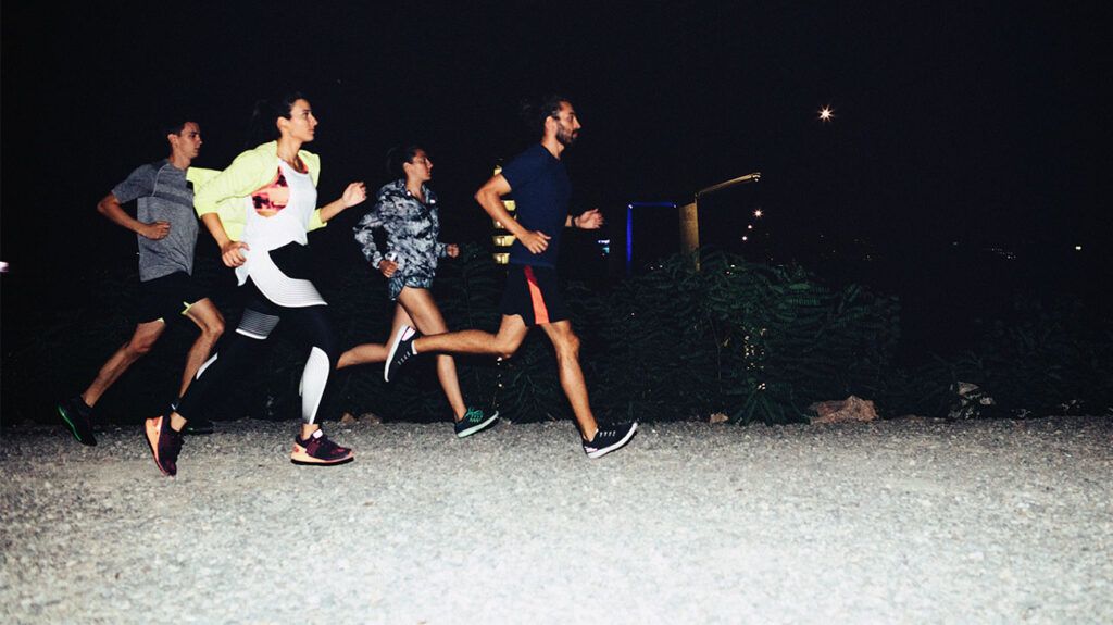 group of people running in the evening