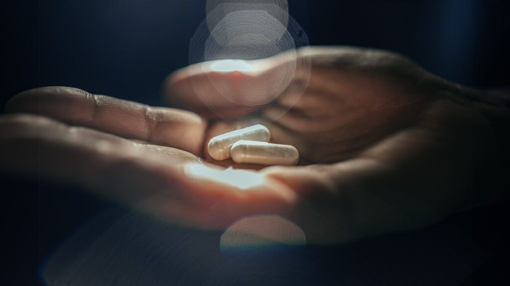 Close up image of antibiotic pills in hand