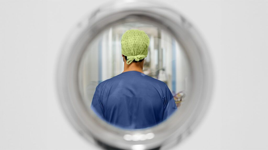 View of a surgeon through a hospital door