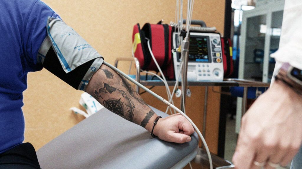 A person getting their blood pressure measured in a hospital setting. -3