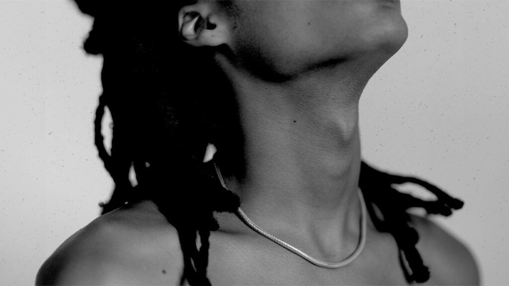 Black and white image of a person's neck