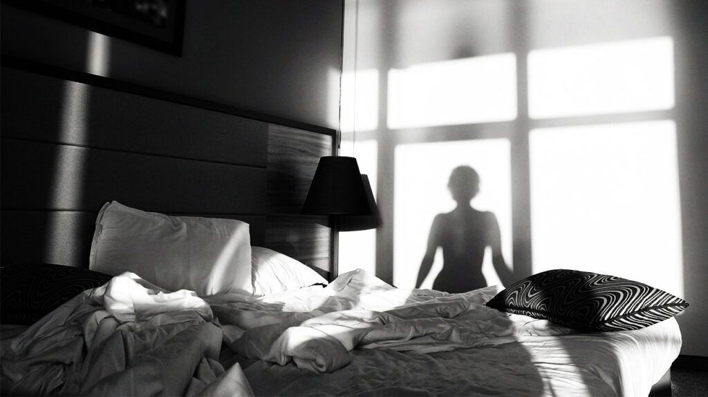 Silhouette of a girl in front of a bedroom window-1