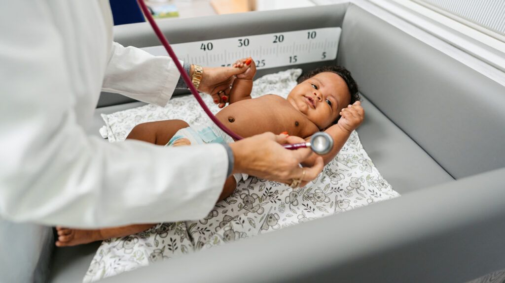 A newborn being examined by a doctor.