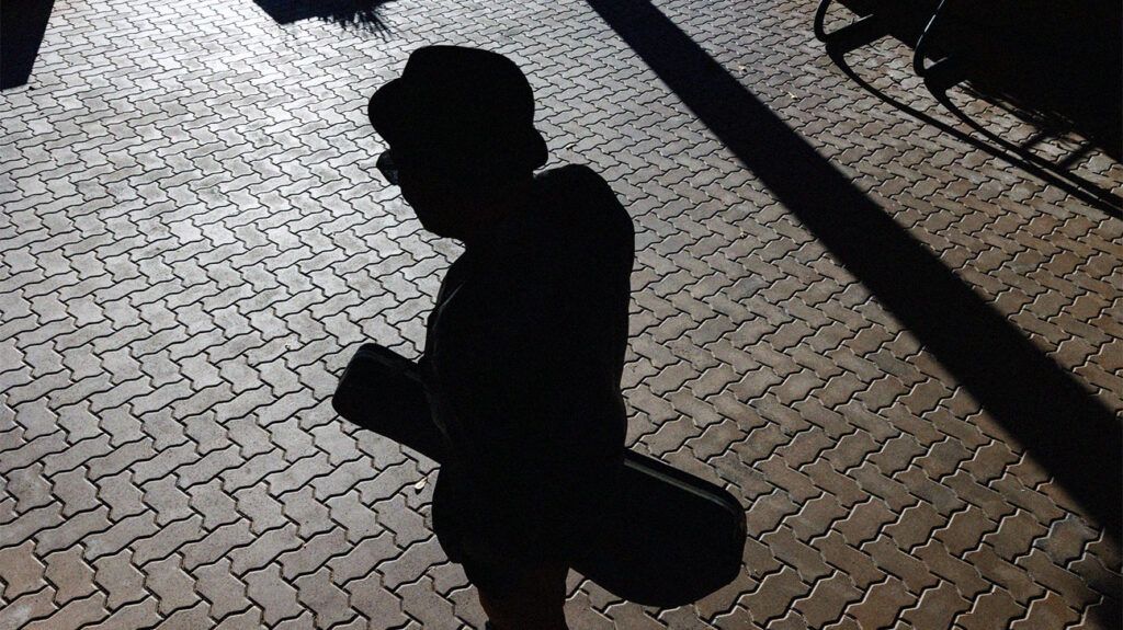 The shadow of a man skateboarding on the floor