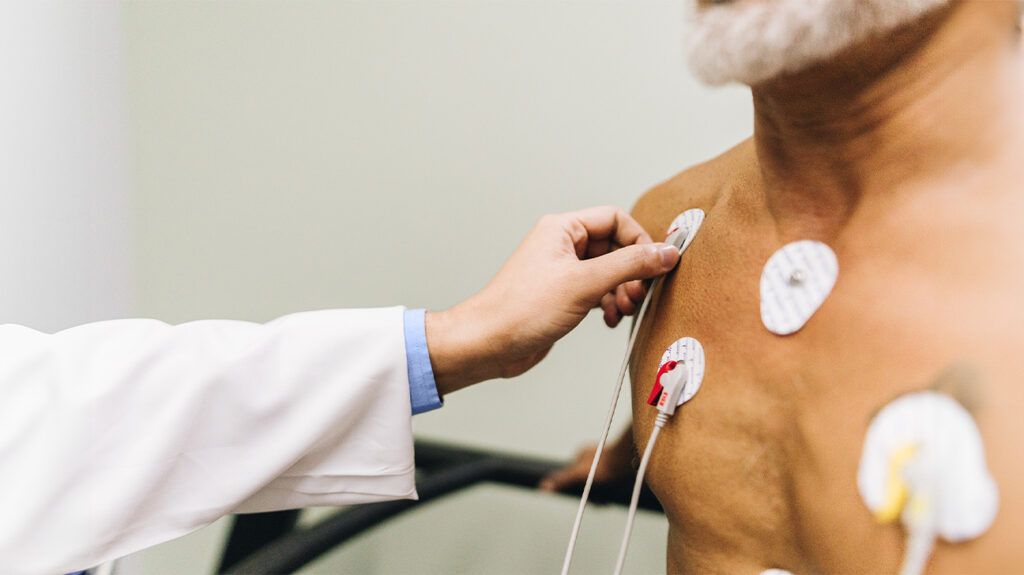 A doctor preparing an ECG test on a patient to detect aortic root aneurysm. -3