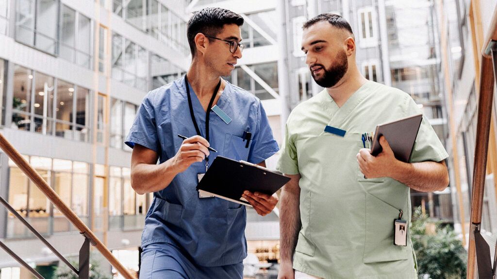 Two medical professionals discussing Drug-induced thrombocytopenia at a hospital. -2