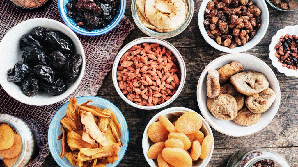 bowls of dried fruits, including raisins, dried apricots, and dried figs