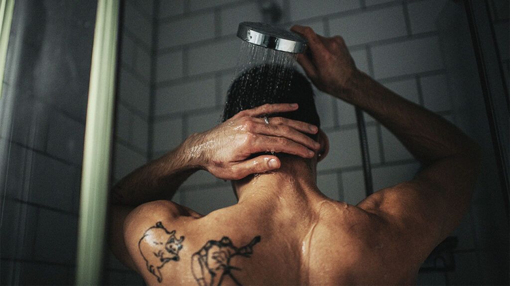 The back of a persons head in the shower 1