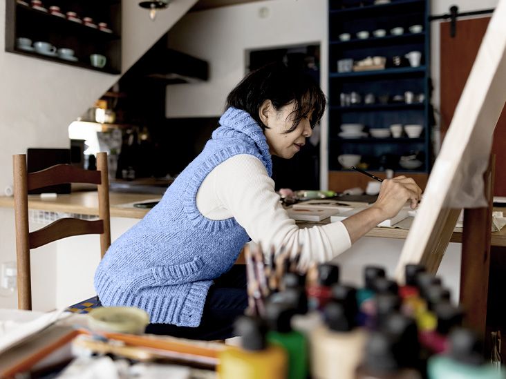 senior woman painting a canvas