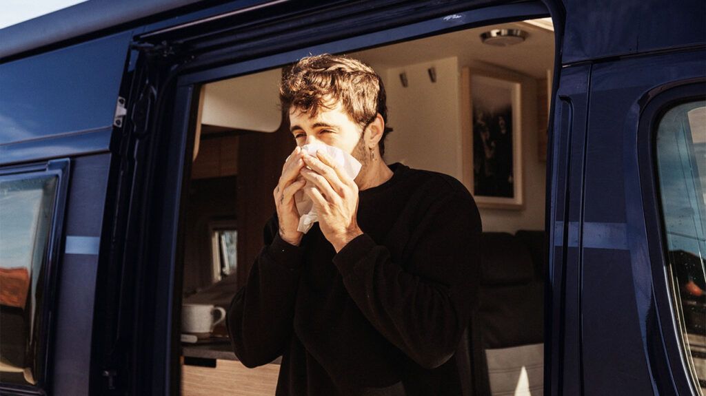 A man coughing into a tissue to represent a subacute cough. -2