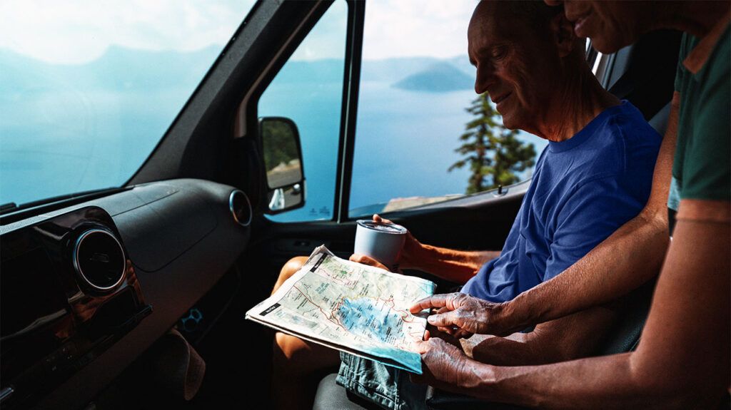 A couple in a vehicle looking at a map