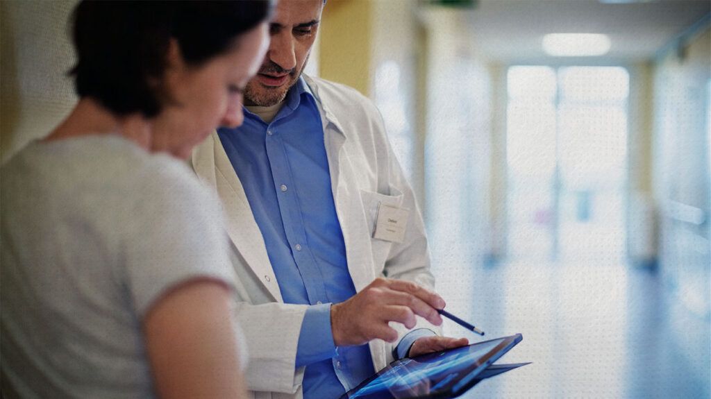 Doctor showing a scan to a female