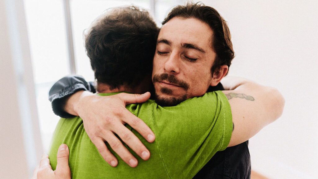 Father and son embracing at home