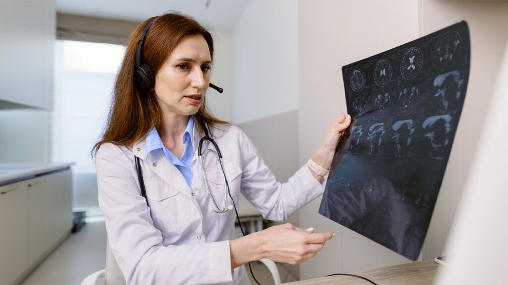 A healthcare professional looking at an imaging scan 1