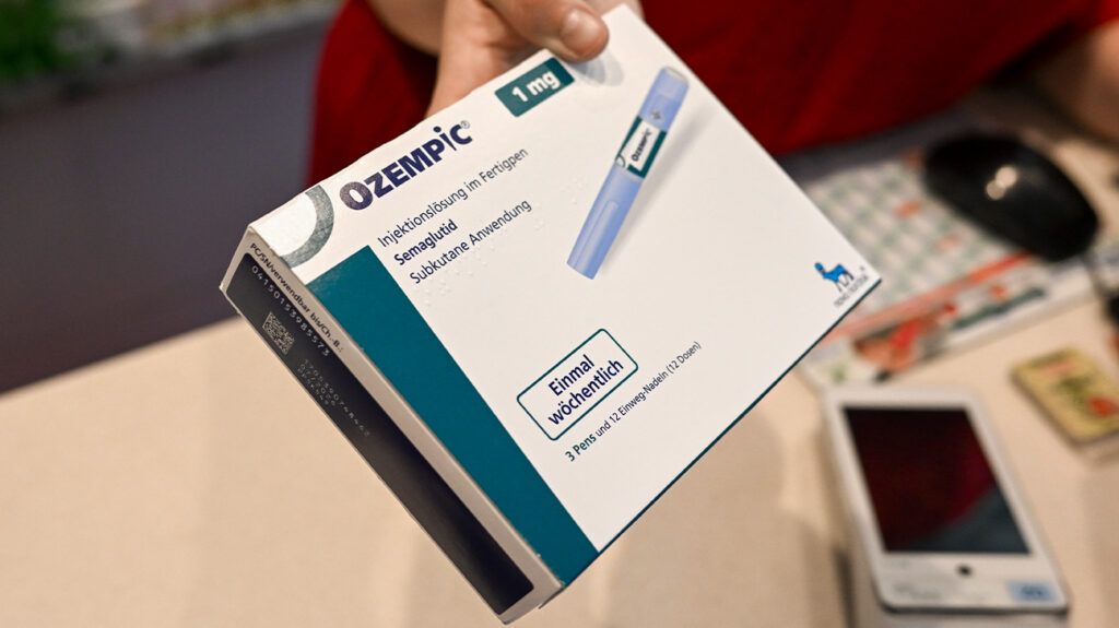 A healthcare professional handing over Ozempic medication-1.