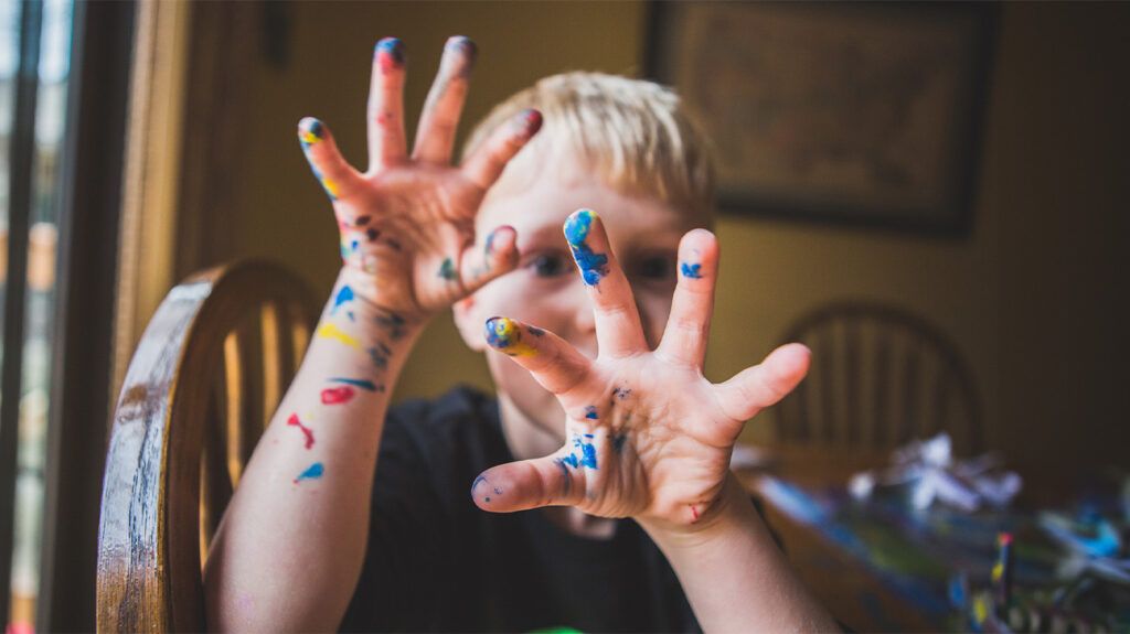 Young child with paint on their hands