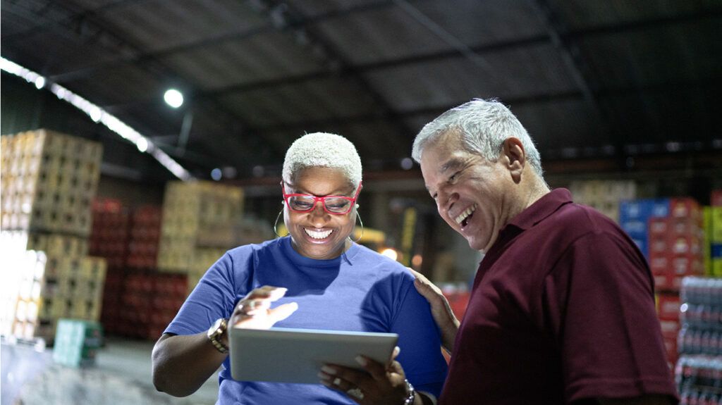 Employees over 65 looking at a tablet