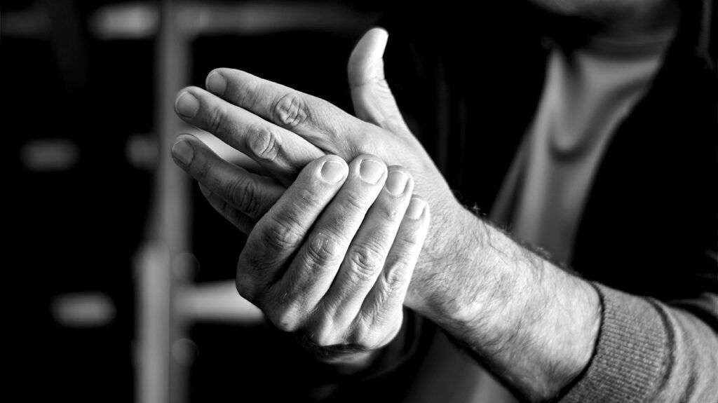 black and white photo showing older person's hands in clasping gesture