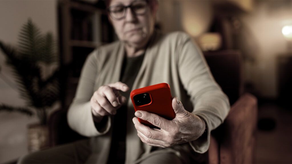 An older person cancelling a call on their phone-1.