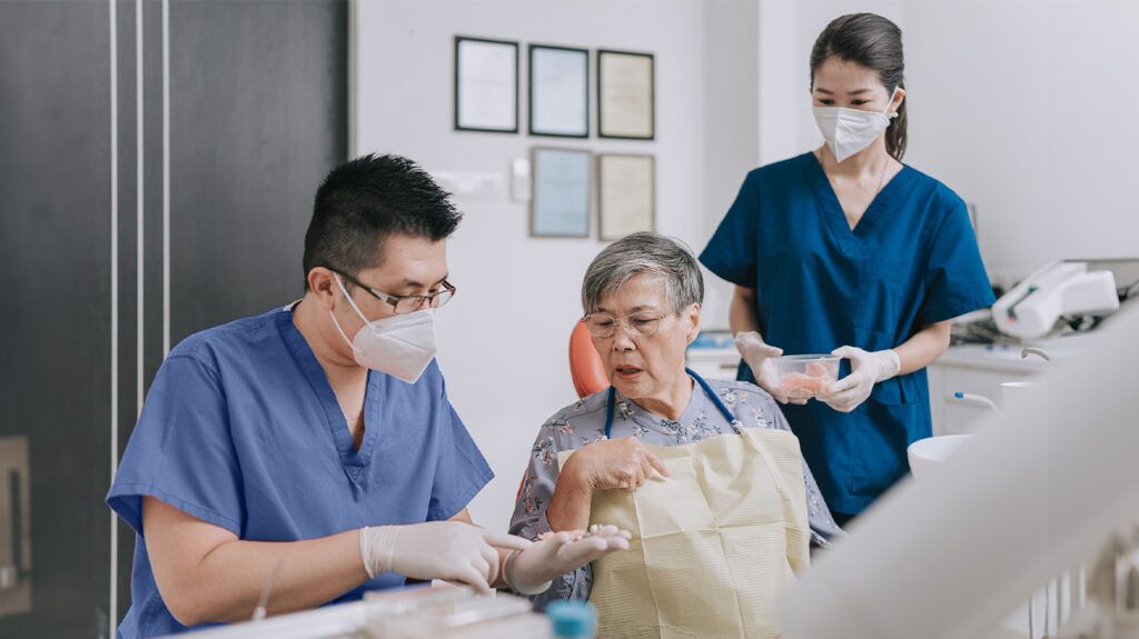 A senior woman receiving a dental check up on Medicaid. -1