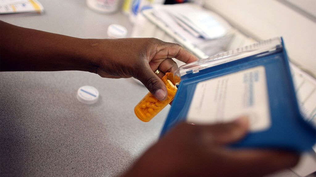 hand holding antibiotics vial