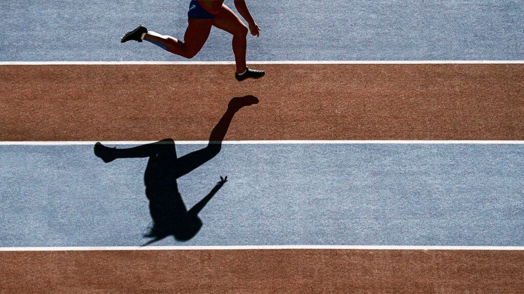 A person running on a track to lose leg fat. -2