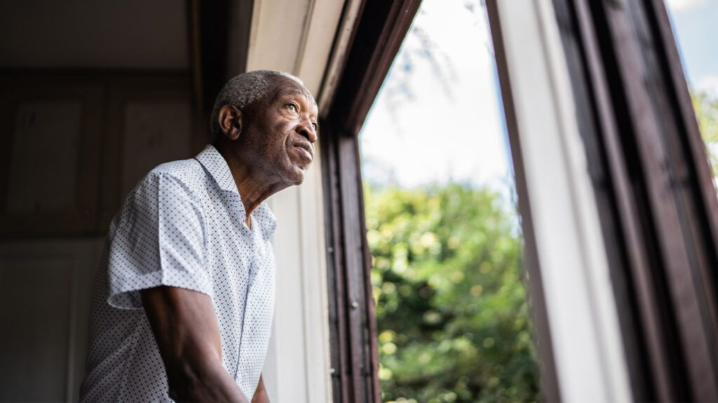 Older male looking out the window