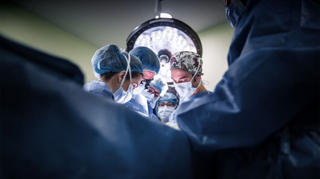 group of surgeons performing surgery