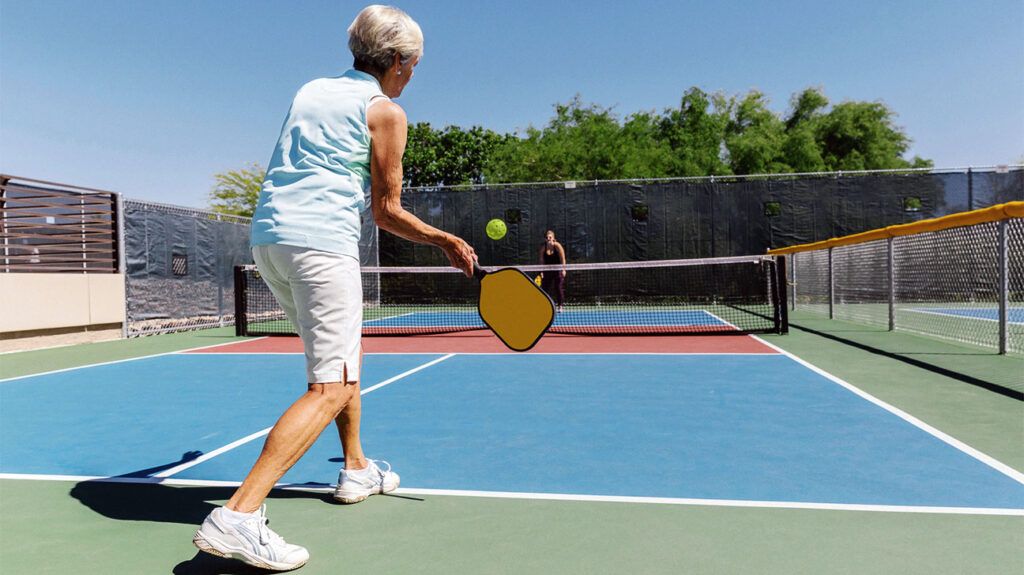 older person playing pickleball