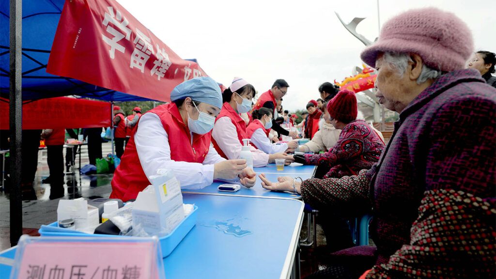 women receiving finger-prick blood sugar tests in China