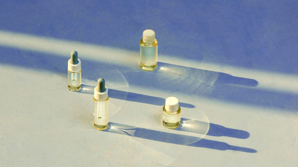 Four clear bottles containing essential oils.