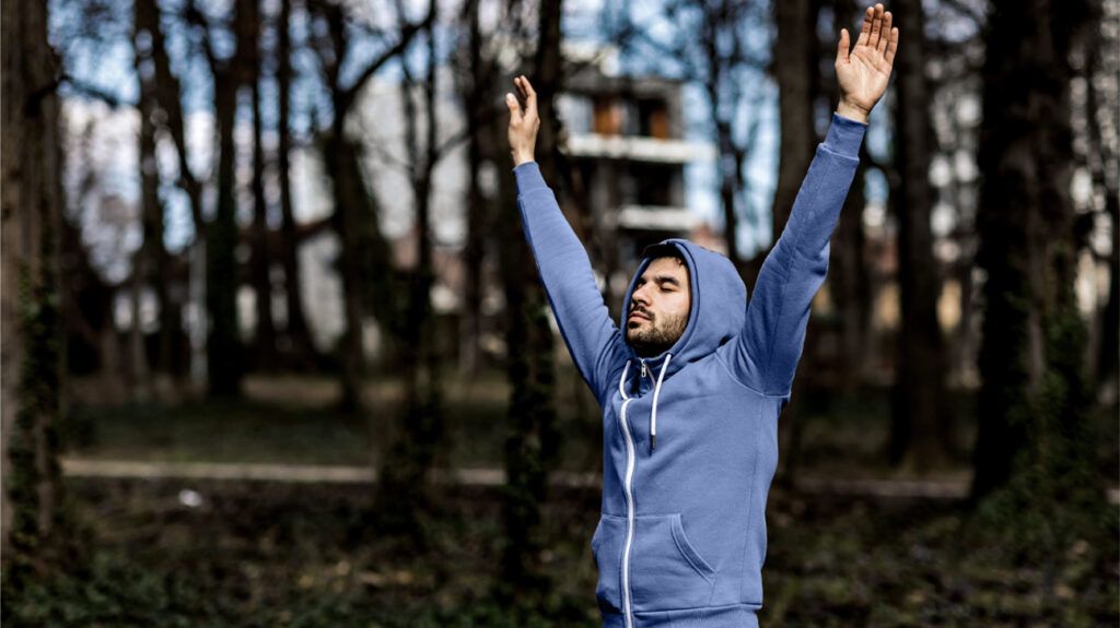 man breathing in woods
