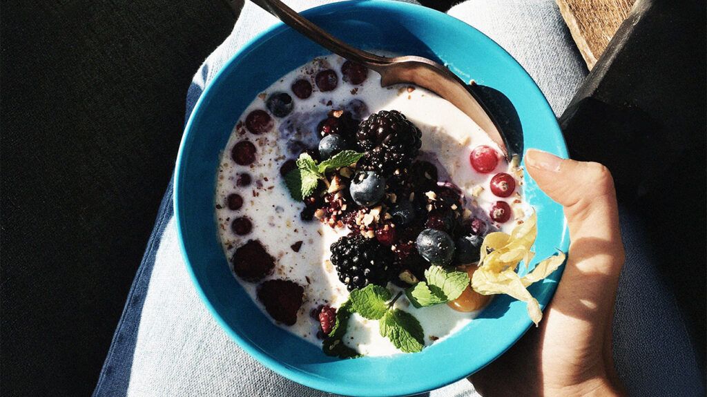 An bowl of oatmeal with fruits and berries.-2