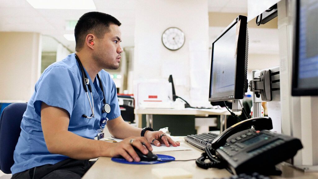 A healthcare professional working on a computer.-2