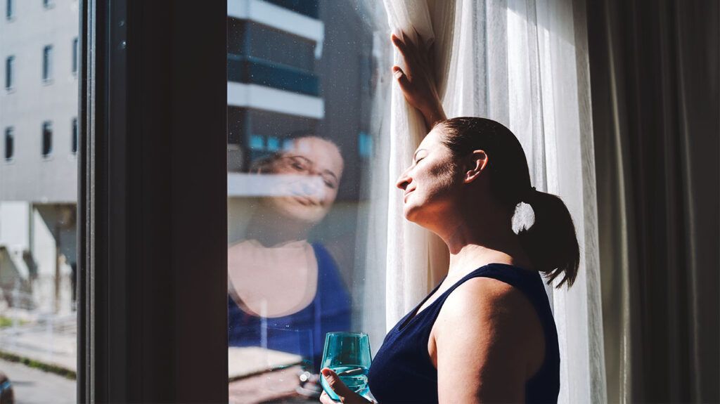 woman looking out window