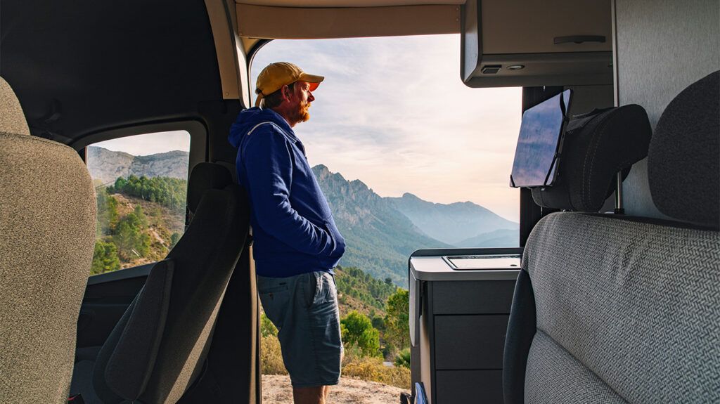 a man looking out onto a hilly landscape