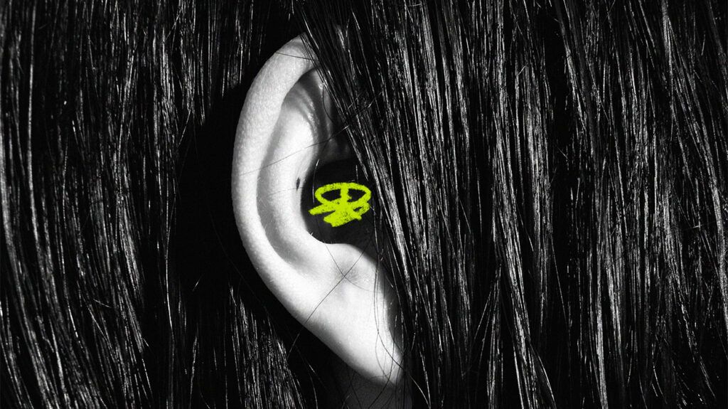 A persons ear poking out from their hair 1