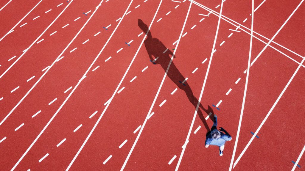 A person with shadow on a running track-1