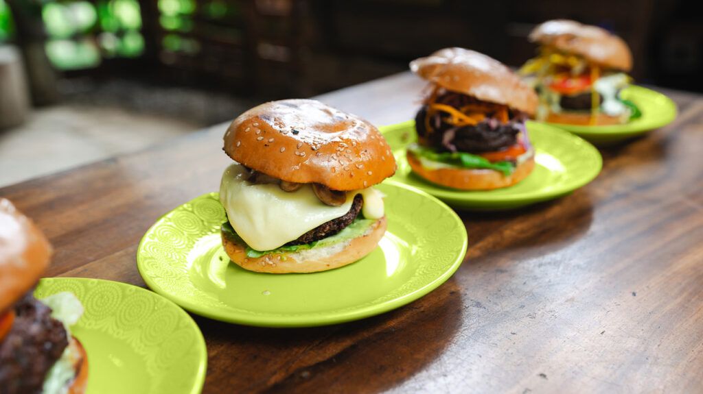 four plates of plant burgers