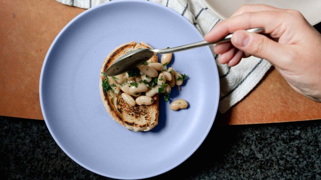 Cannellini beans with herbs on a piece of toast on a plate