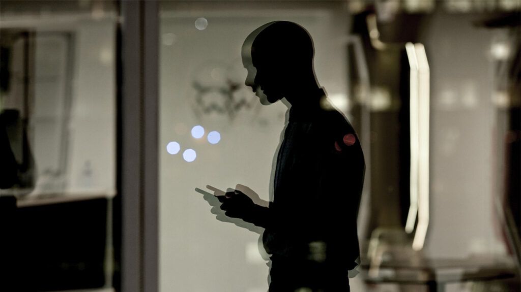 dark silhouette reflected in window