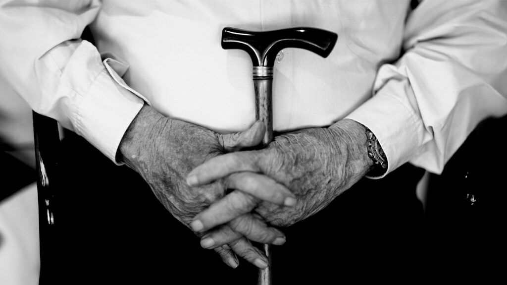 Older male holding a cane