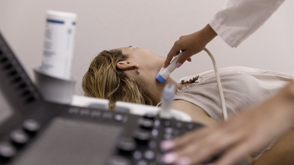 A person undergoing an ultrasound to diagnose the type of thyroid cancer.