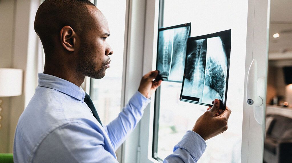 a doctor looking at X-rays images against a window-1