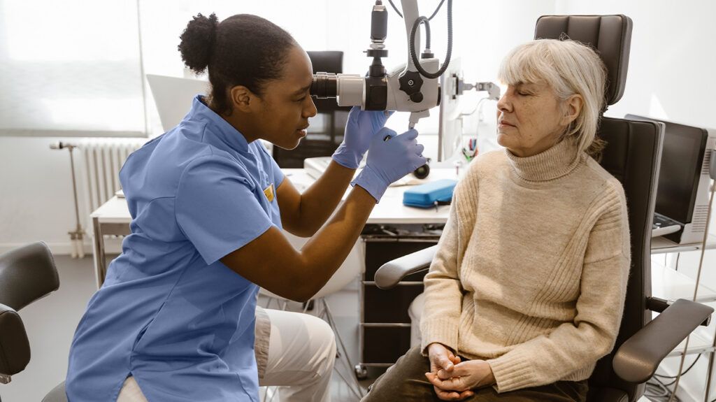 An eye doctor examining a person with a traumatic cataract.